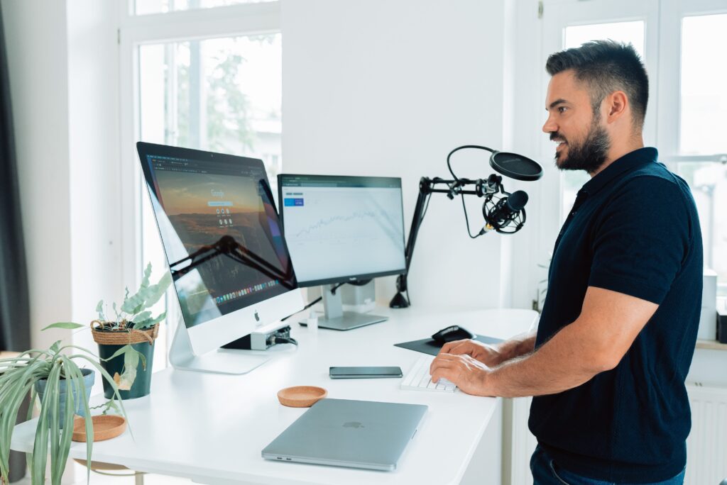 Man Podcasting at Standing Desk - How Do You Start a Successful Podcast
