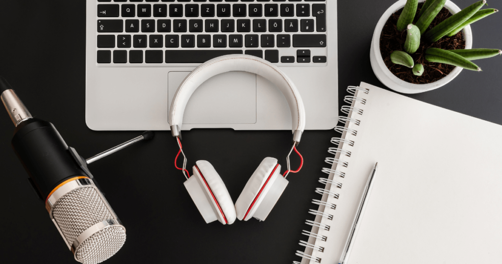How to Start a Health and Wellness Podcast - Microphone and Headphones with Laptop and Notepad