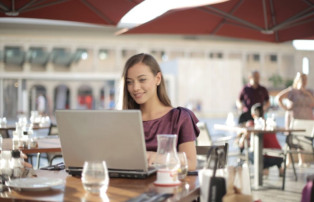 Can You Start an Online Business for Five Bucks - Woman Smiling Looking at Laptop