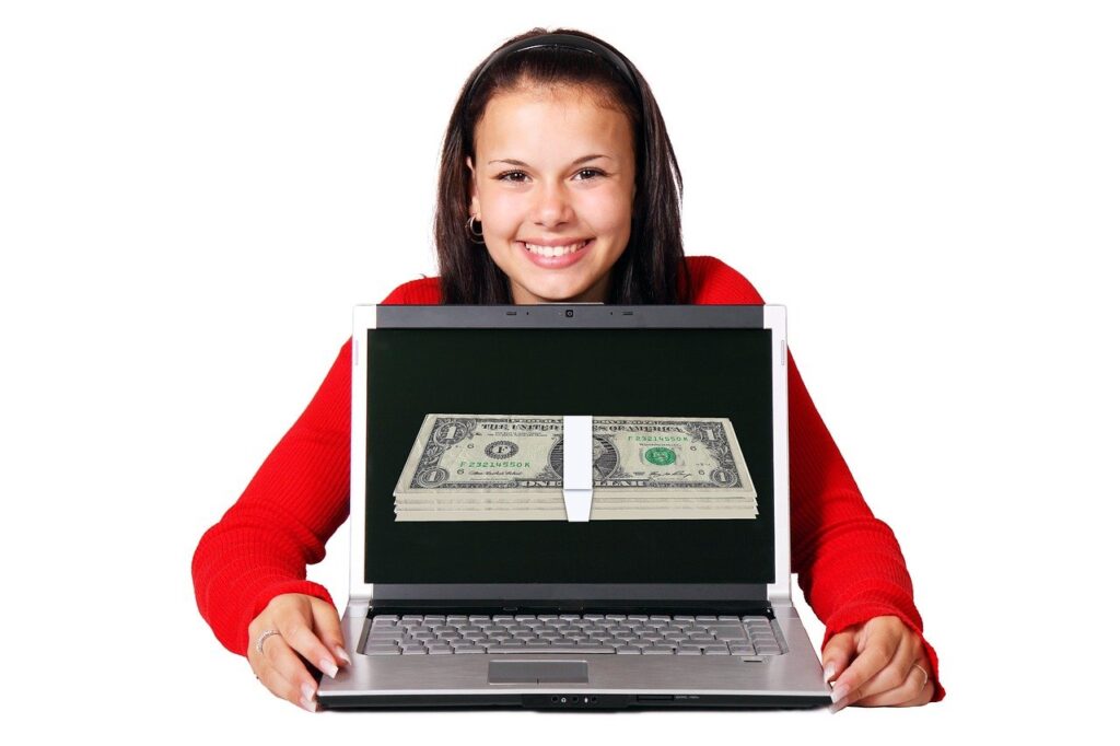 Steps to Affiliate Marketing Profits - Woman Holding Laptop with Money On Screen