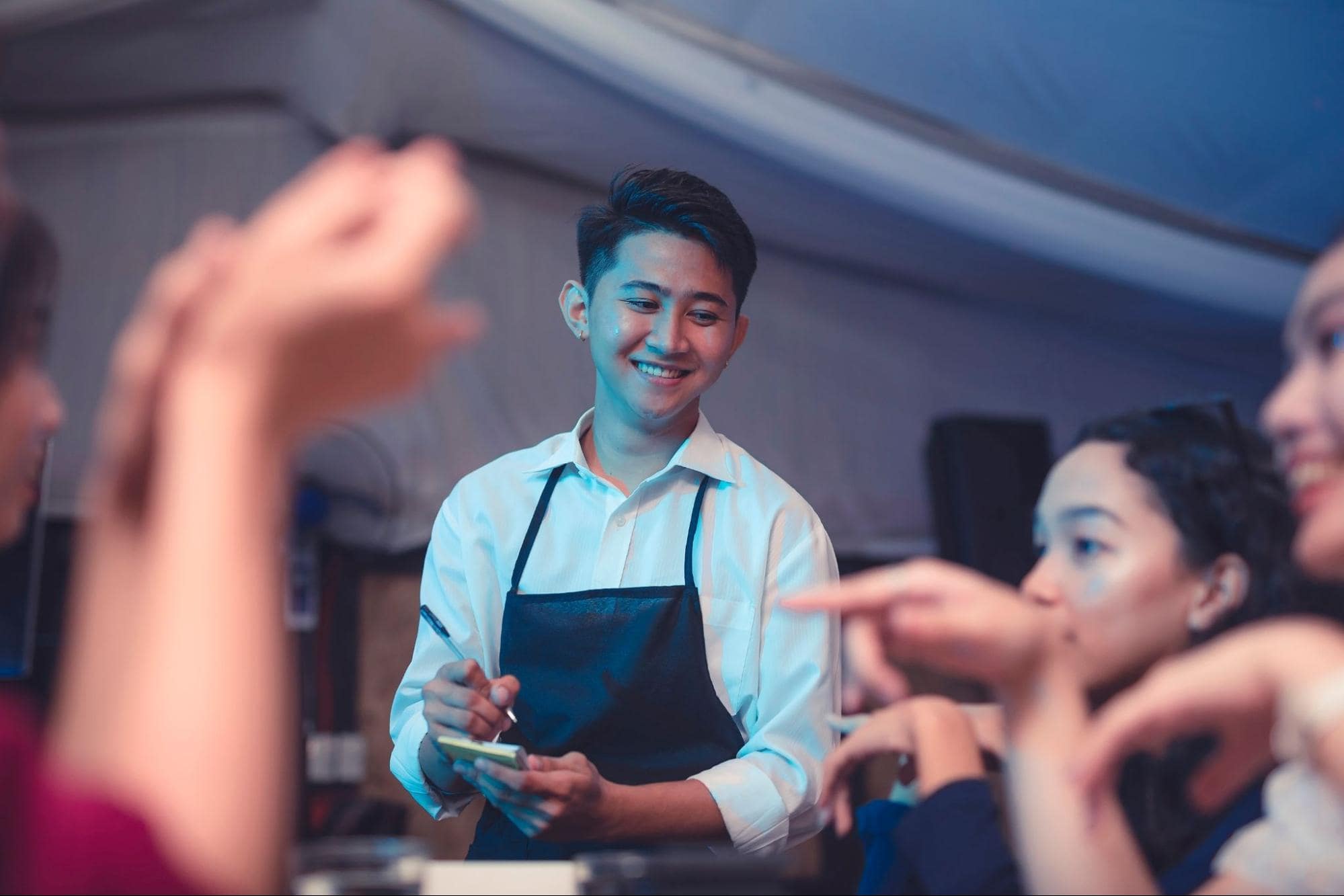 Hospitality Industry Waiter Taking Order from Large Party