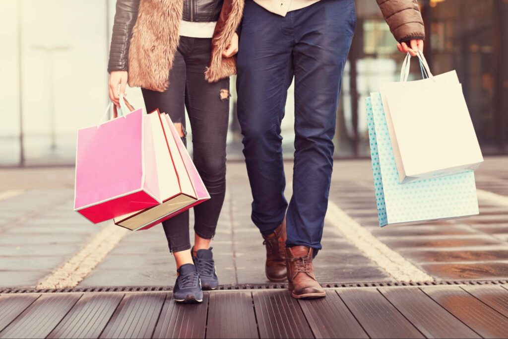 Annual Income Couple Walking Holding Hands with Shopping Bags 
