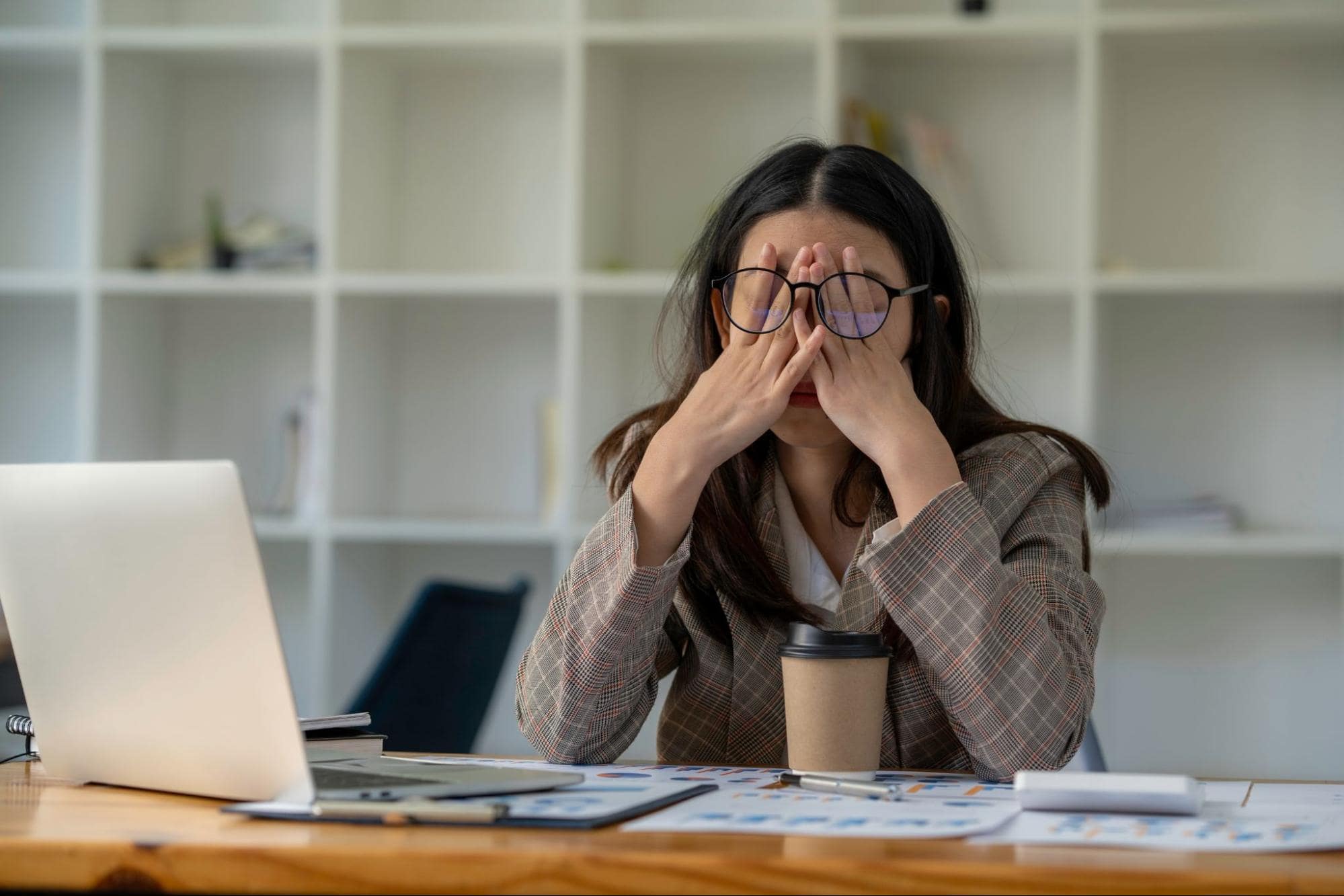 time-saving-tools-overwhelmed-woman-at-desk-covering-face